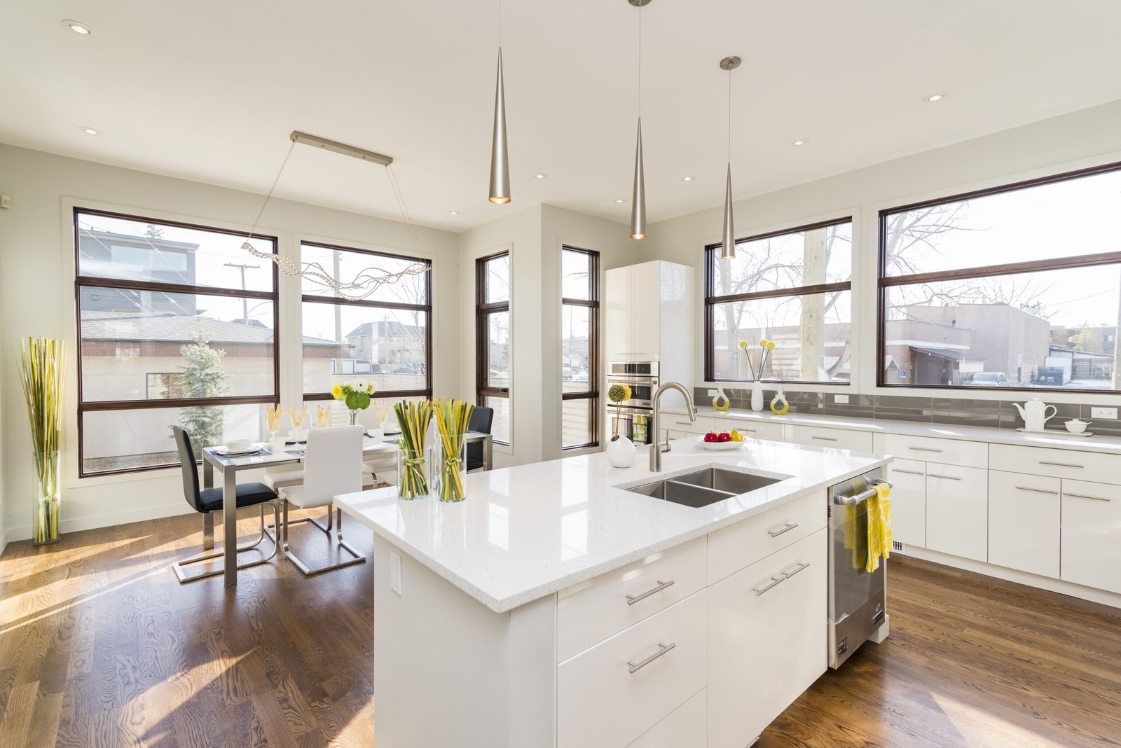 An interior shot of a modern house kitchen with large windows